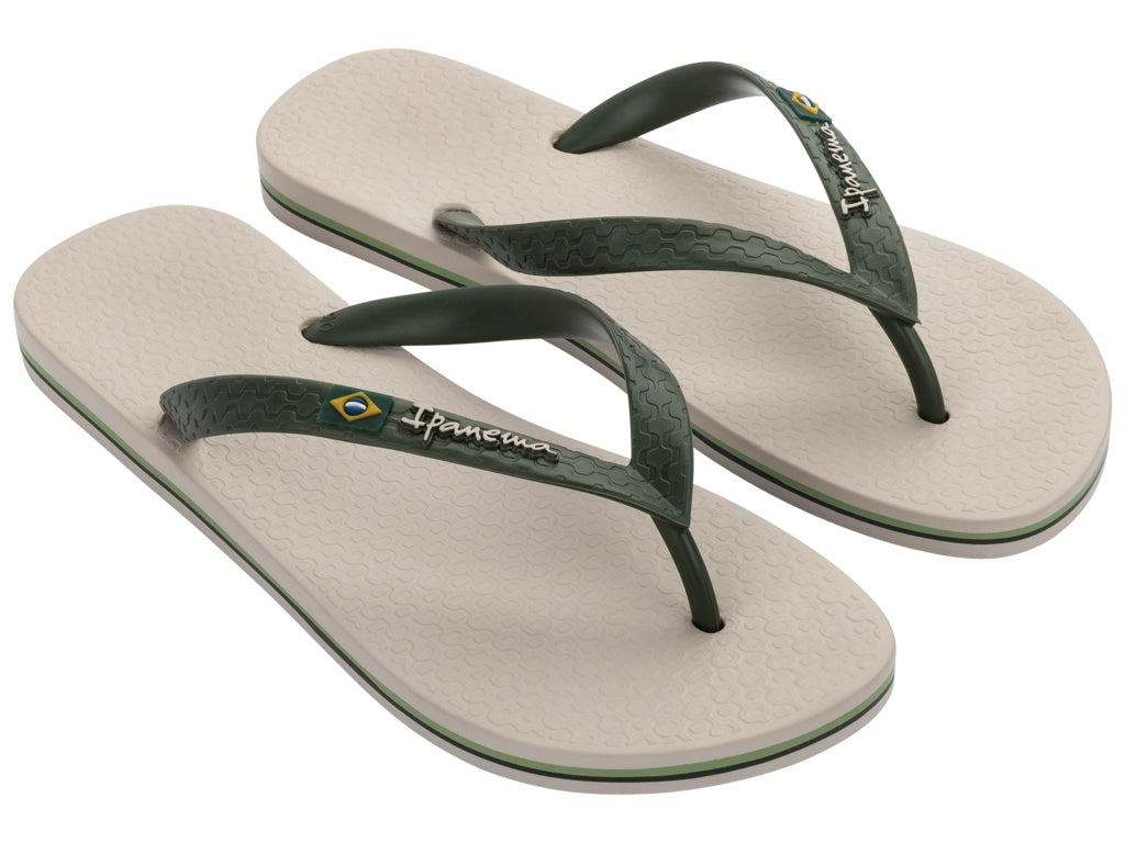 Pair of beige and green flip-flops with ipanema logo on a white background