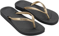 Black and gold flip-flops with 'Ipanema' branding on a white background