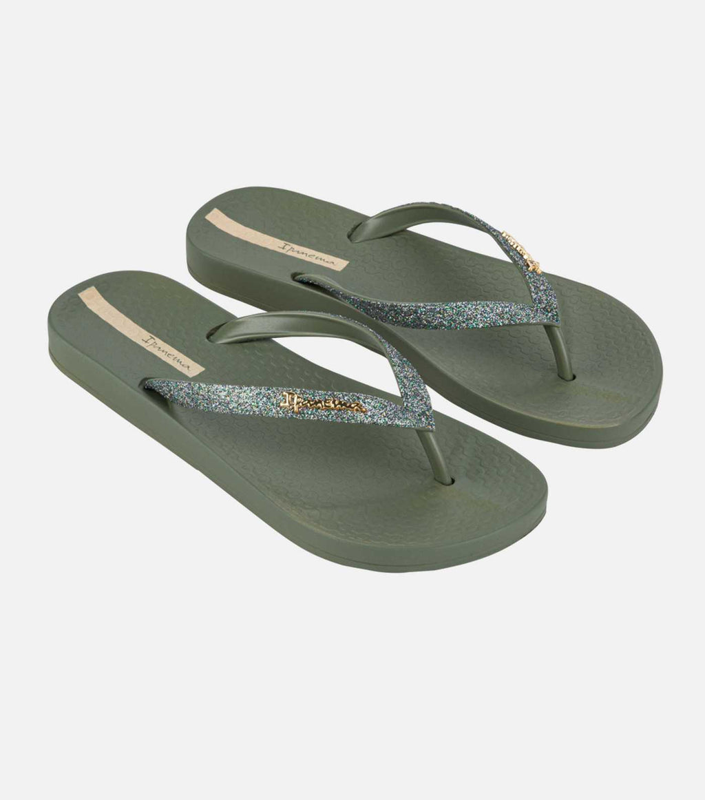 Pair of green flip-flops with glittery strap on a white background