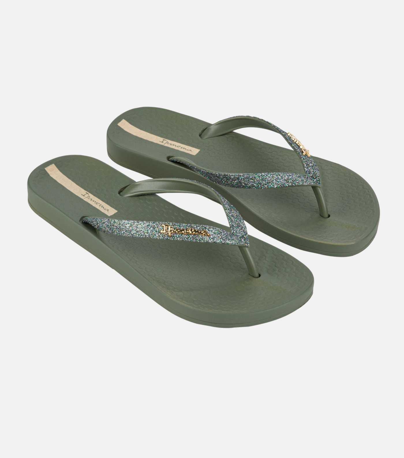 Pair of green flip-flops with glittery strap on a white background