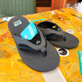 Gray reef sandals with a blue tag on a map background