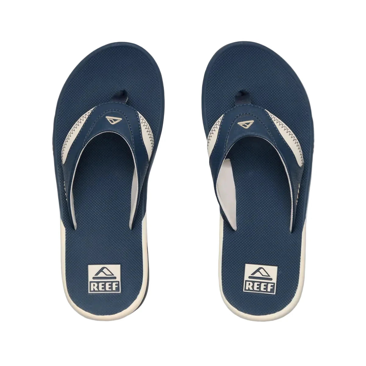 Pair of navy blue and white Reef sandals on a white background