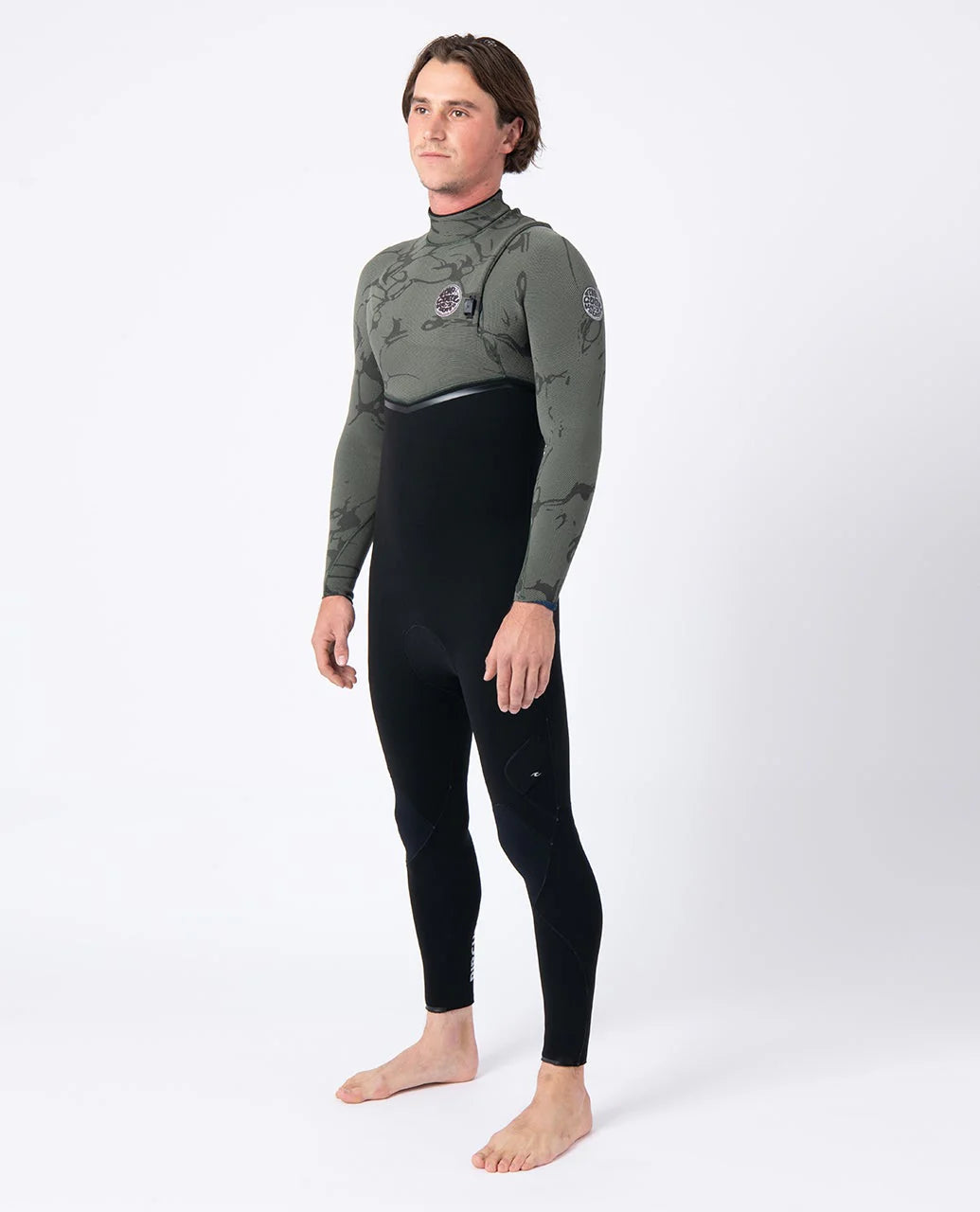 Person wearing a black and green wetsuit on a white background