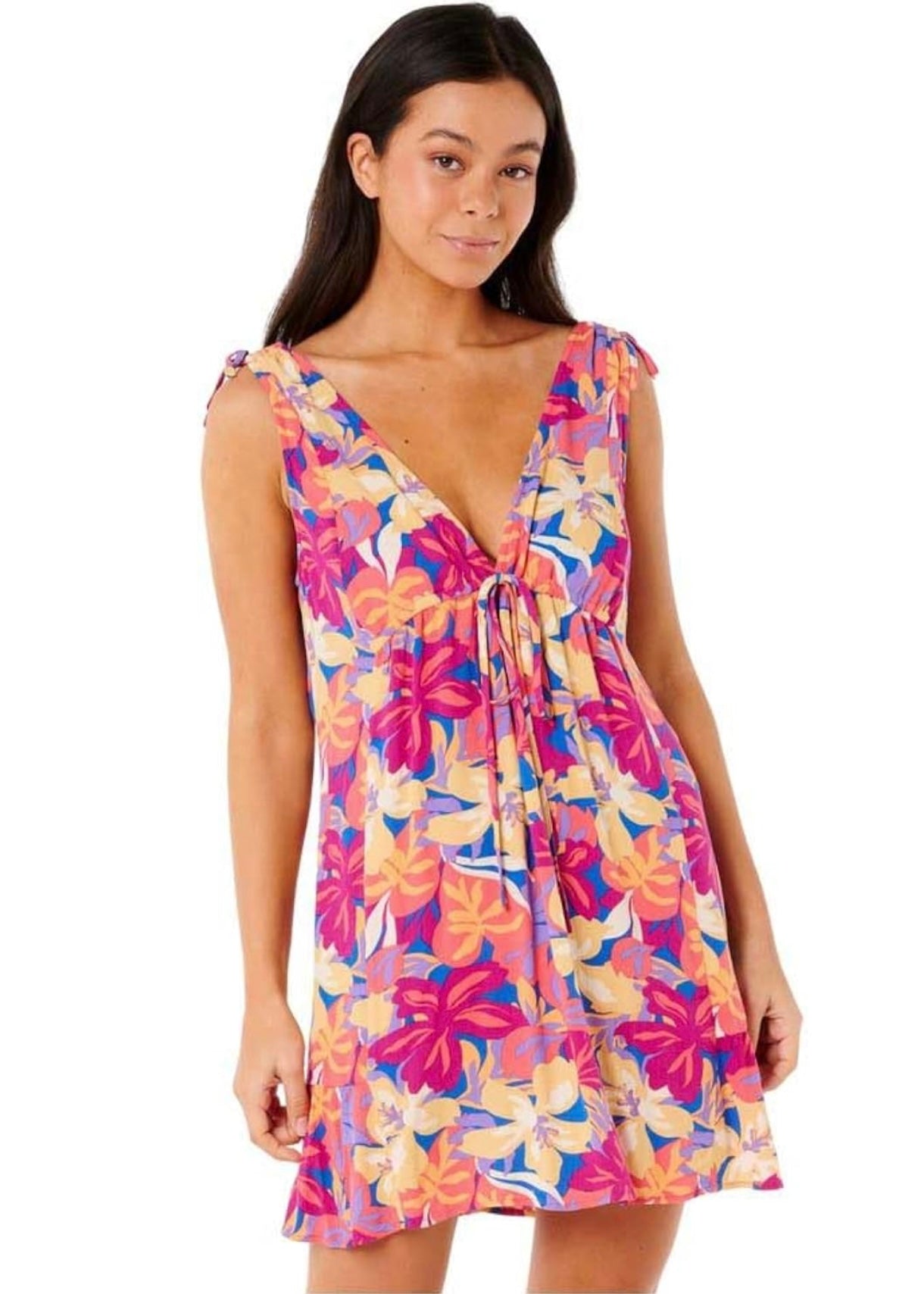 Woman wearing a colorful Ripcurl floral dress on a white background