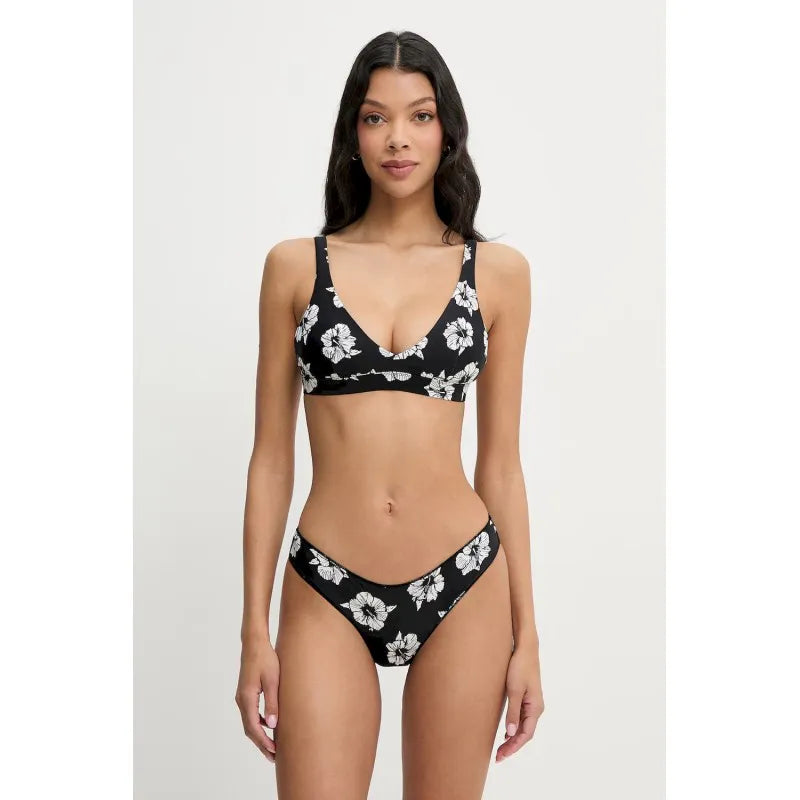 Woman wearing a black floral bikini set on a white background