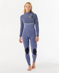 Person wearing a blue Ripcurl zipperless wetsuit on a white background
