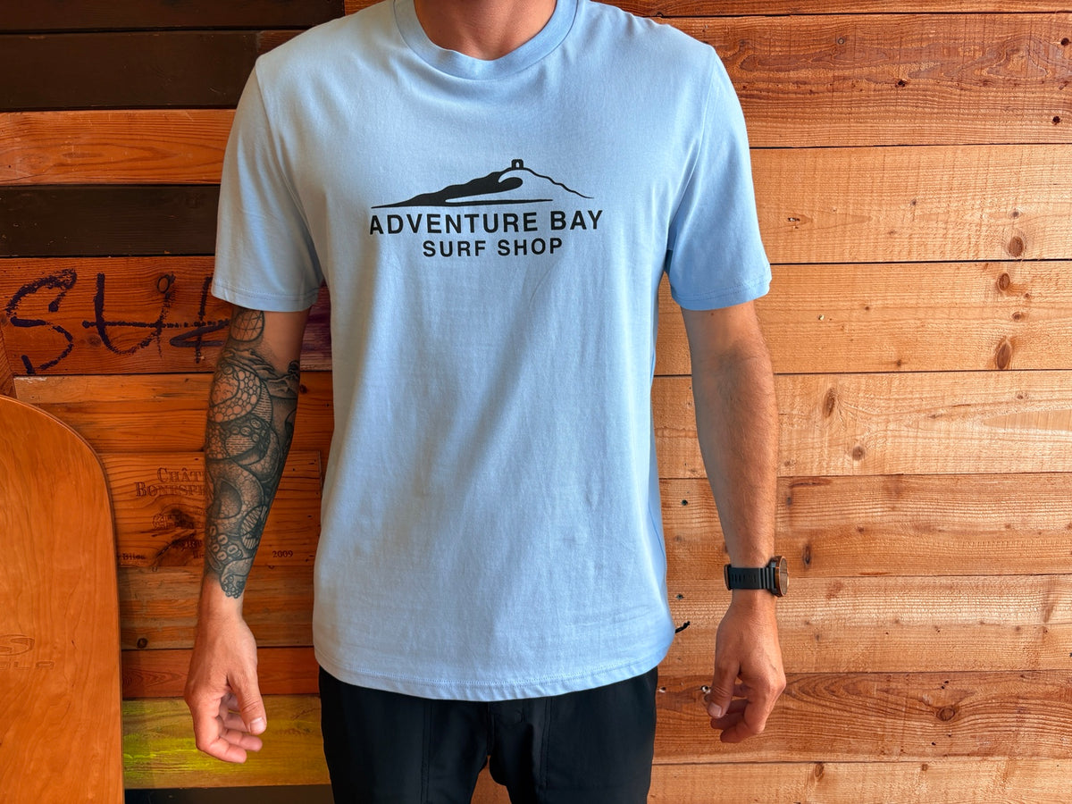 Adventure Bay Surf Shop chest logo tee in blue worn by male model