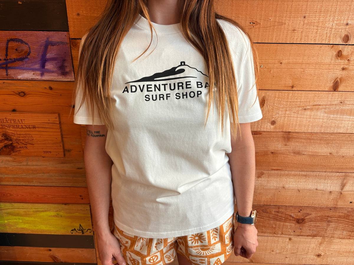 Adventure Bay Surf Shop chest logo tee in bone worn by female model