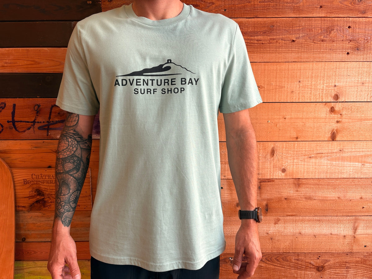 Adventure Bay Surf Shop chest logo tee in green worn by male model