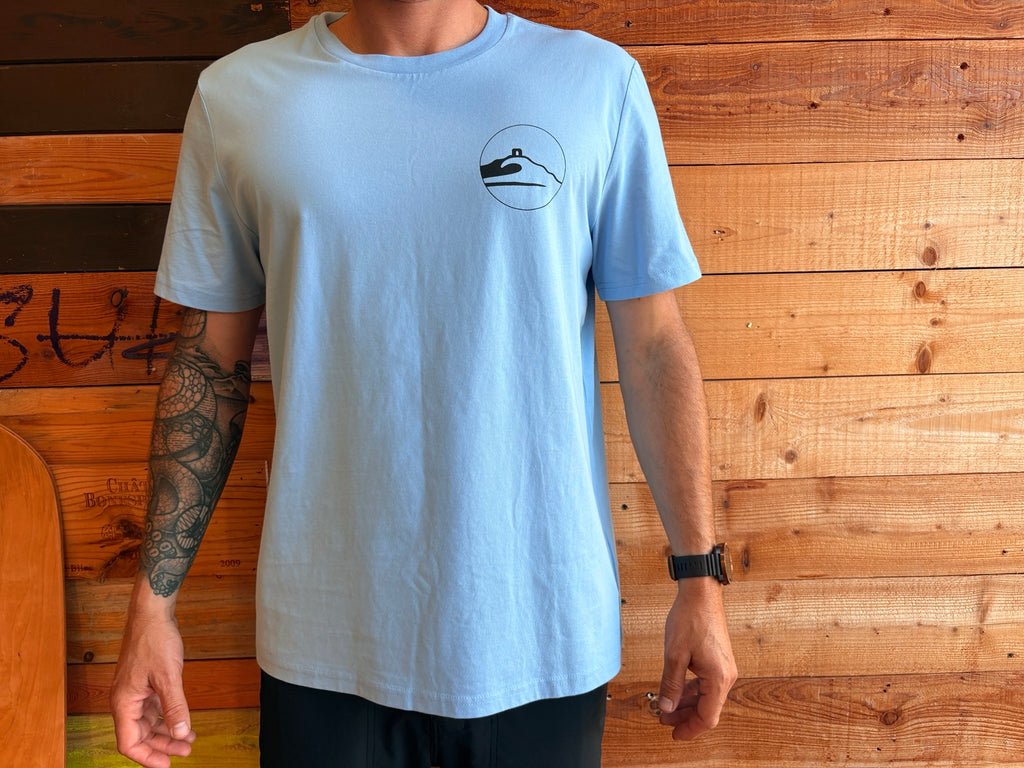 Adventure Bay Surf Shop round logo tee in blue front view worn by male model