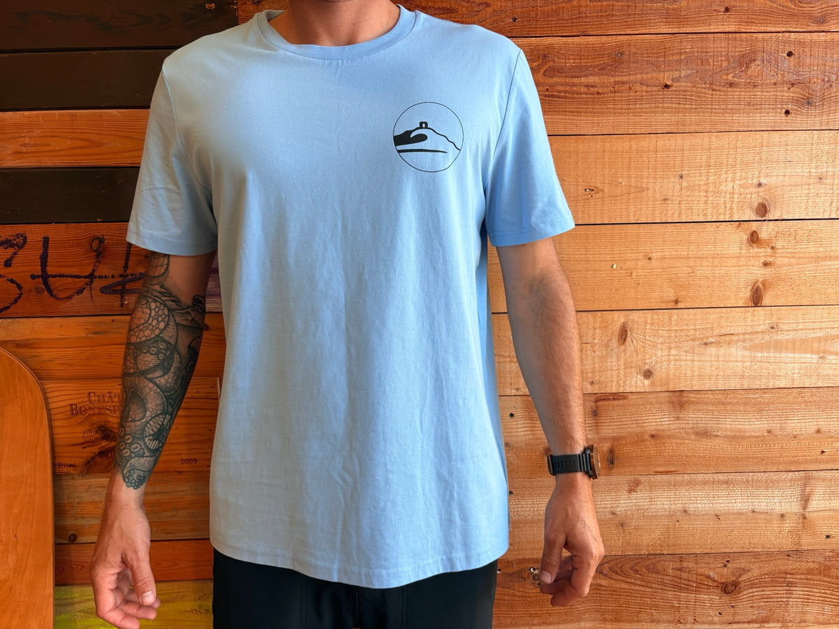 Adventure Bay Surf Shop round logo tee in blue front view worn by male model
