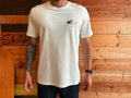 Adventure Bay Surf Shop round logo tee in bone front view worn by male model
