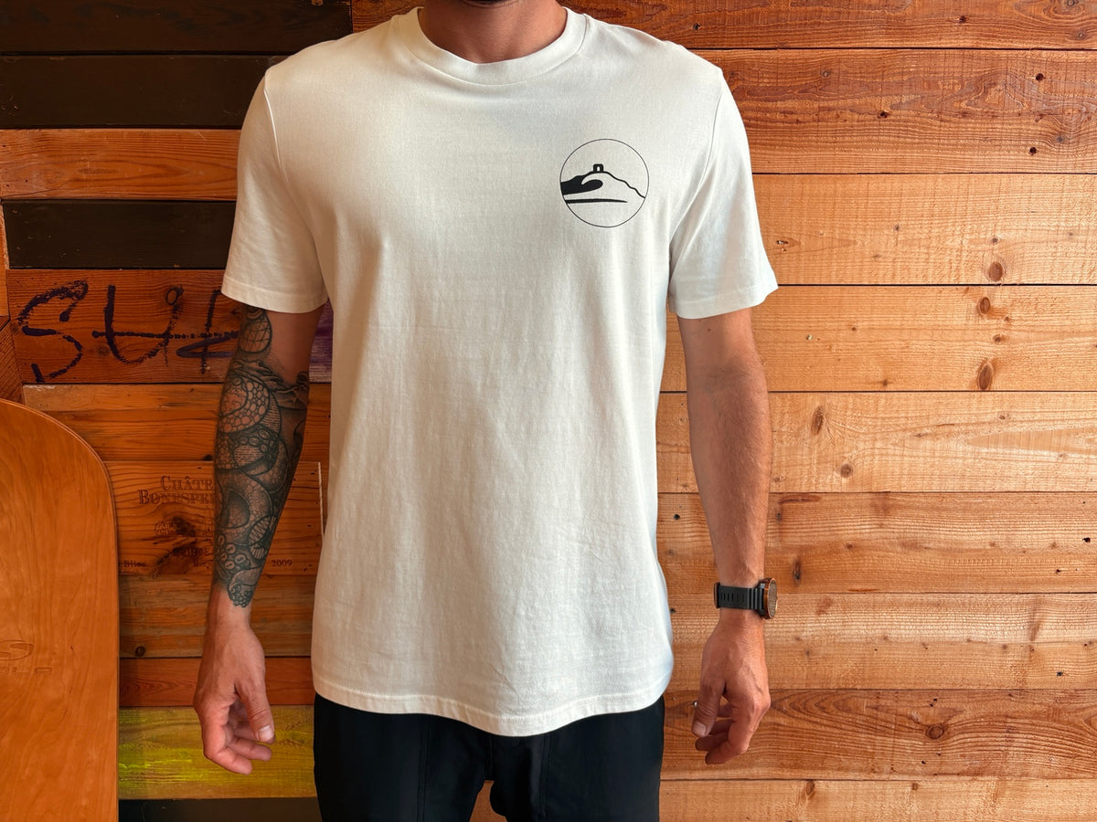 Adventure Bay Surf Shop round logo tee in bone front view worn by male model