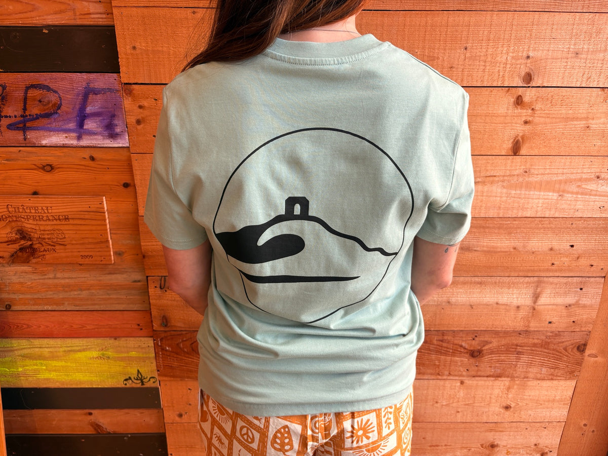 Adventure Bay Surf Shop round logo tee in green back view worn loose by female model